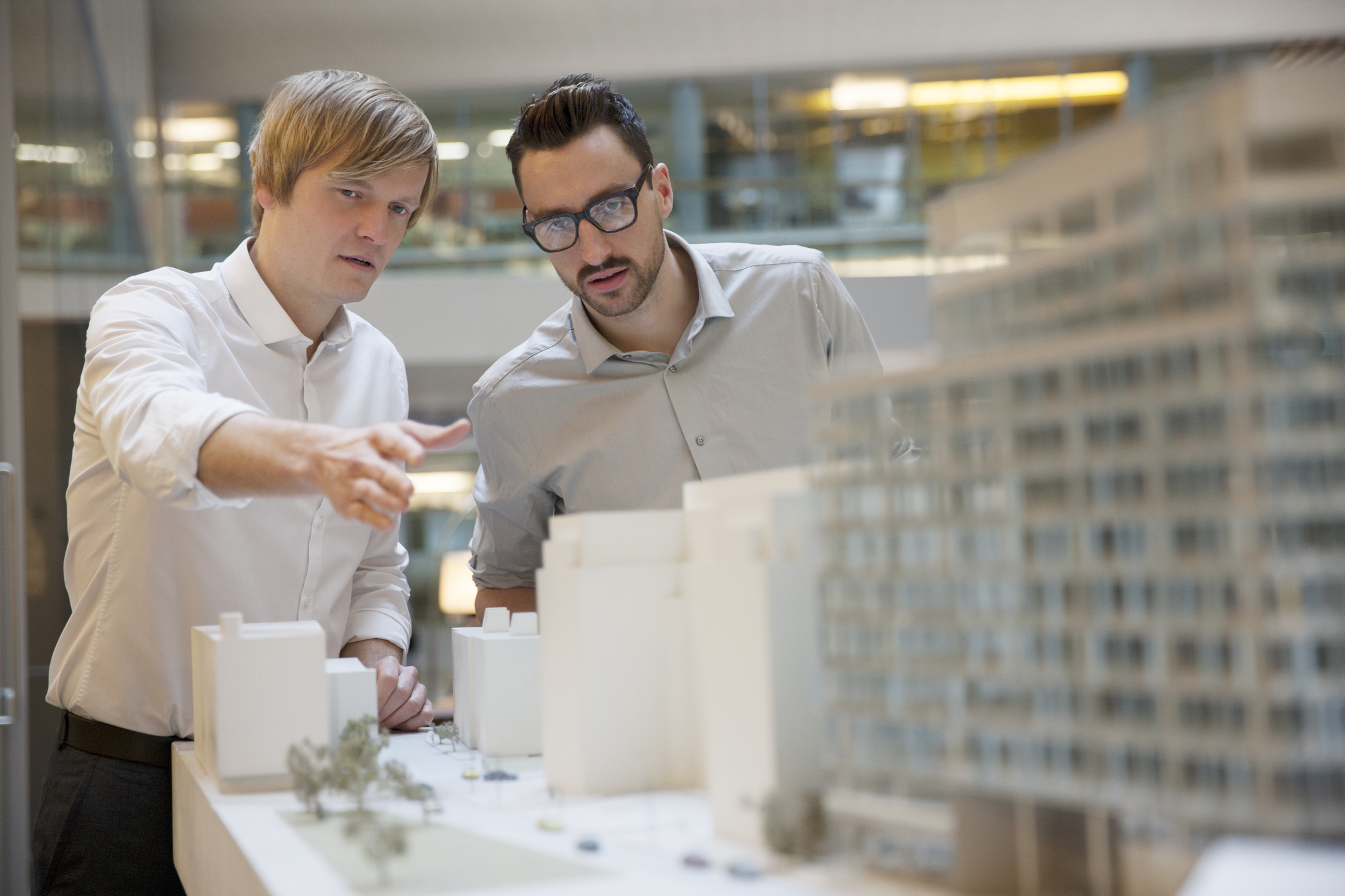 Business people looking at model building